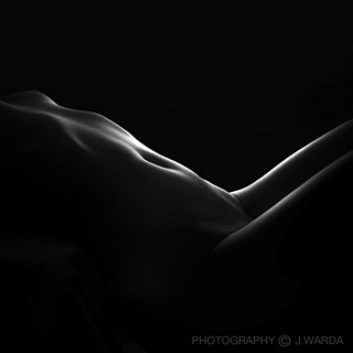 reclining silhouette of a nude female body photographed by j.warda the naked pixel photography 